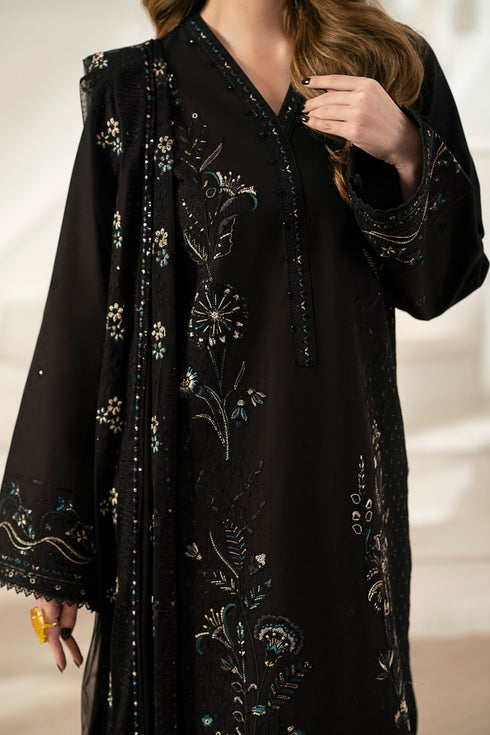 Model wearing full NAQSHI Moheeni 3PC: heavily embroidered black cambric shirt, straight pants & ornate net dupatta—showing complete look