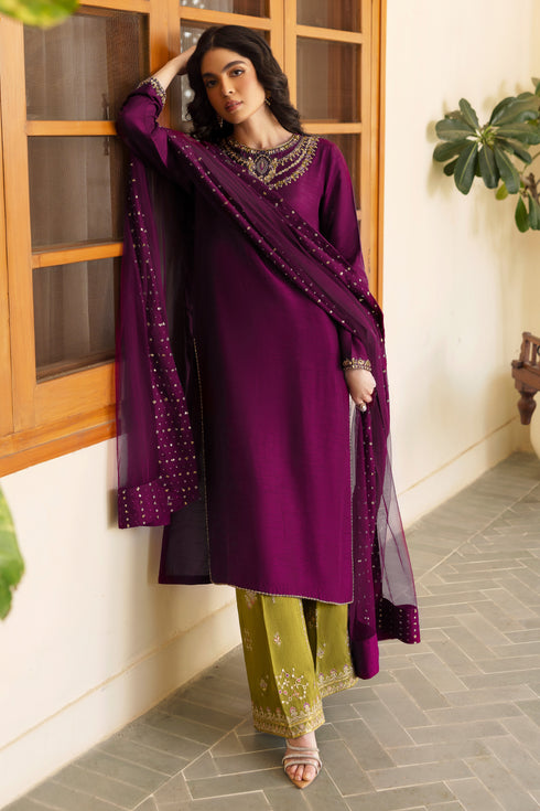 Detailed shot of NAQSHI Irma shirt hem showing pure hand-adda work—kora, dabka, sitara, cut dana, crystals & stonework—on wine-purple raw silk.