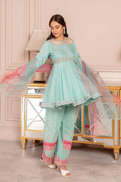 Standing pose of Glory powder blue dress showing peplum silhouette and flowing dupatta styling, elegant ready made festive outfit.