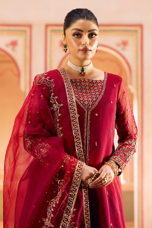 Full view of flared PK raw‑silk trousers with embroidered, sequin-trim hem.