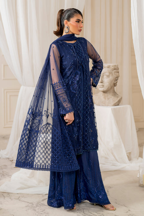 Side profile of naqshi nayal displaying flared cutline, bold flower embroidery, textured mid‑panel and flowing culottes for elegant evening wear.