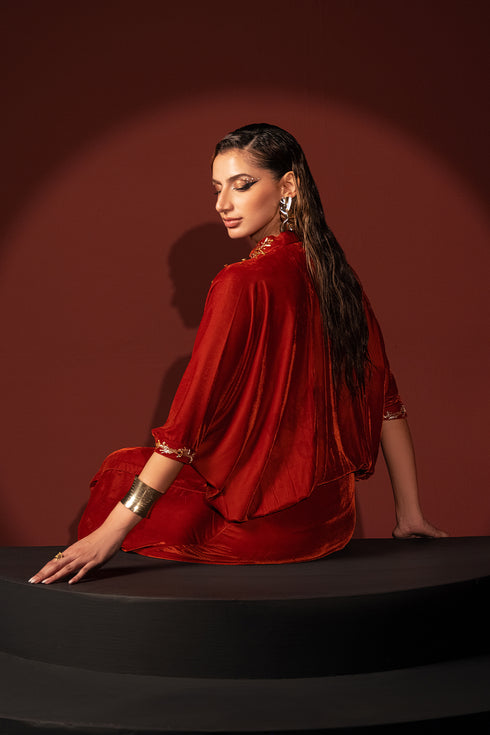 Back seated view of Shayna blood orange kaftan showing flowing fabric and clean finish, elegant ready made evening wear.