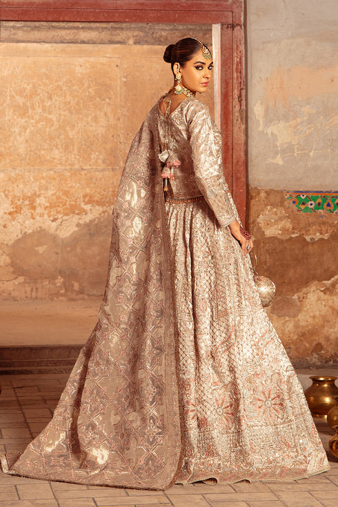 Side shot of Raniya showing lehenga flare with kora‑dabka embroidery, tissue cut‑line choli with tassel hangings and dupatta drape.