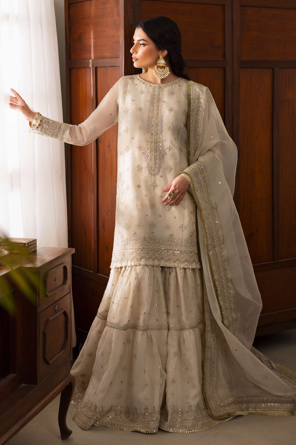 NAQSHI Jeena pearl-white organza shirt featuring a boat neckline crystallized with stones, floral sequin embroidery across front, paired with lavender-tinged gypsy gharara and embroidered dupatta.