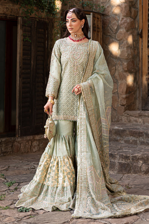 Naqshi Mah‑e‑Meer pistachio raw‑silk short organza shirt covered in heavy hand‑adda—kora, dabka, crystals, sitari, cut‑dana, resham flowers—paired with gypsy gharara and potli bag.