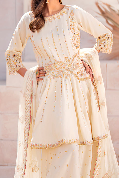 Close-up of Diana’s sleeve cut-work and adda embroidery detail on raw‑silk fabric.