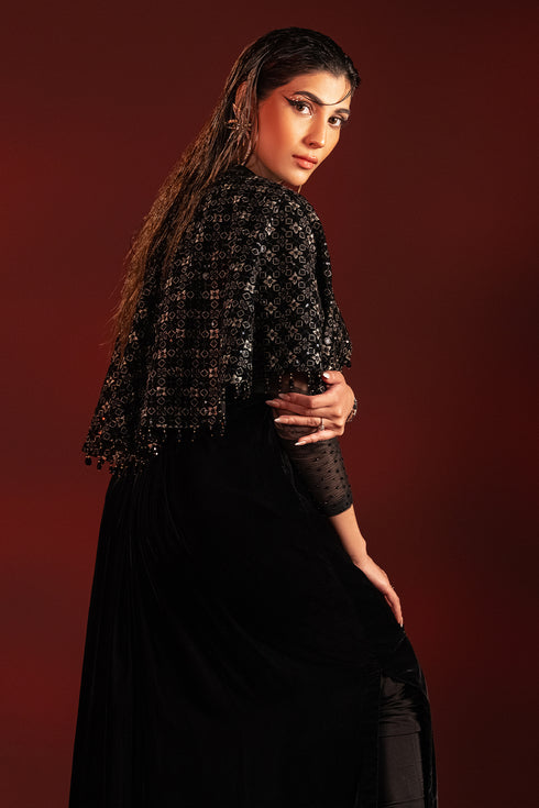 Back styling pose of Ayna outfit highlighting embroidered cape layer and tassel detailing, ready to wear evening formal attire.