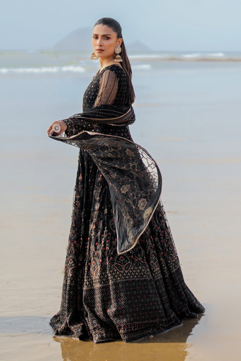 Close‑up of NAQSHI Blain sleeve cuff highlighting floral embroidery, sequin texture and handmade crystal hangings on net fabric.