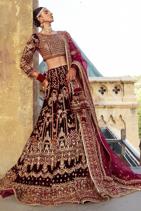 Side view of NAQSHI Parivarsh bridal set showcasing velvet lehenga flare, intricate panel embroidery, texture play, straight silhouette and fitted sleeves.