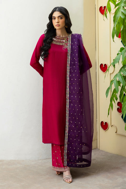 NAQSHI Raima hot-pink Indian raw silk straight shirt with heavily hand-adda embellished near-to-neck neckline—kora, dabka, sitara, crystals, threadwork—paired with purple organza dupatta.