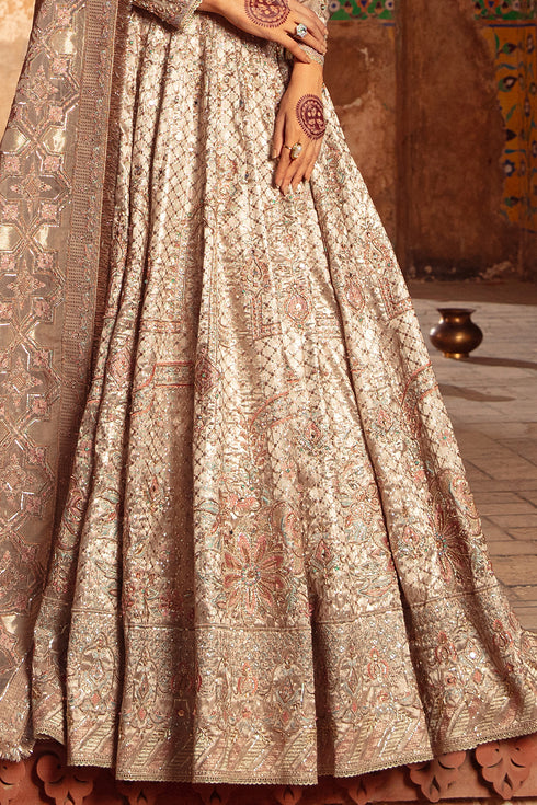 Model styled in full Naqshi Raniya 4PC ensemble: copper-peach choli, lehenga, embroidered pouch & dupatta styled for regal wedding elegance.