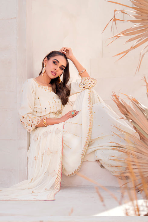 Model wearing Naqshi Diana 3PC set styled elegantly for formal occasions with peplum shirt, sharara & dupatta.