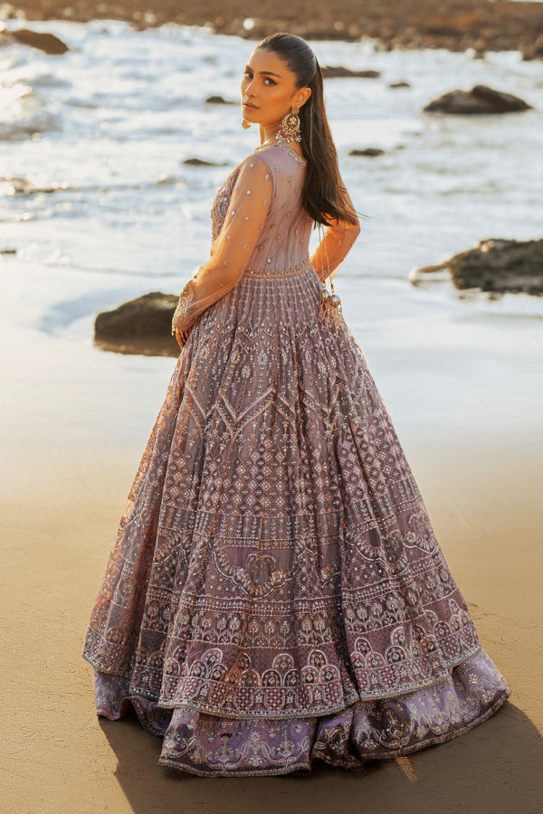 Side view of NAQSHI Liana showcasing full sleeves adorned in hand‑adda embroidery, flowing multi‑layered net silhouette, and attached can‑can for added volume.
