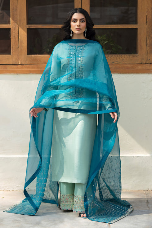 Close‑up of NAQSHI Tania machine‑embroidered raw‑silk culottes featuring monochromatic sequin borders and tonal aqua stitching.