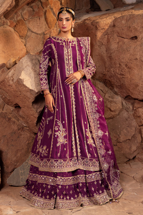 Naqshi Jugnu deep-violet raw-silk front-open frock richly embellished with heavy hand‑adda techniques—kora, dabka, crystals, sitari, cut-dana, tilla, payal, naqshi—over matching lehenga.