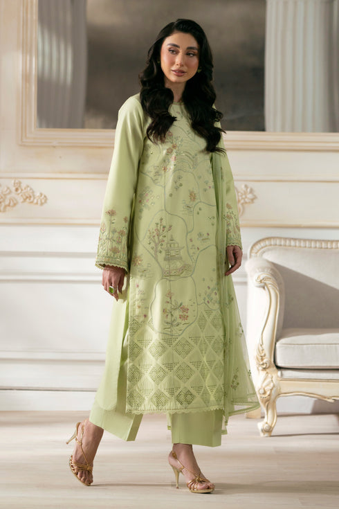 Side view of NAQSHI Sitara showcasing straight cambric shirt with lace and sequin‑trim sleeves, revealing clean silhouette with matching straight pants.