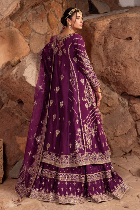 Side silhouette of Naqshi Jugnu showcasing princess-panel frock cutline, embroidery flowing along seams, and lehenga flare in bold violet hue.