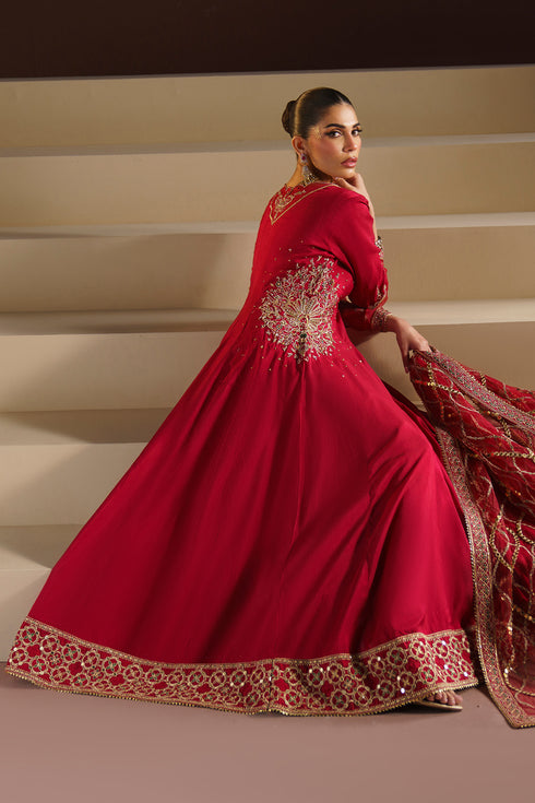 Side angle of NAQSHI VANI red formal outfit showing flowing raw silk panels and dupatta drape