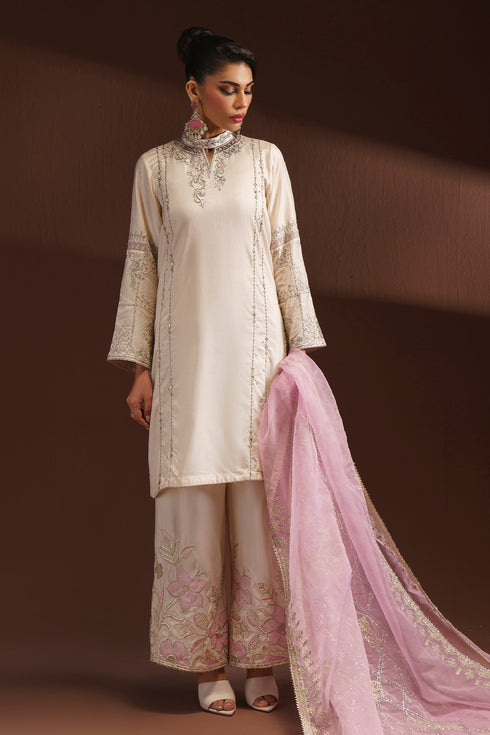 Front standing view of NAQSHI AMSAH egg shell luxury pret dress highlighting culotte trousers and ban neckline embroidery