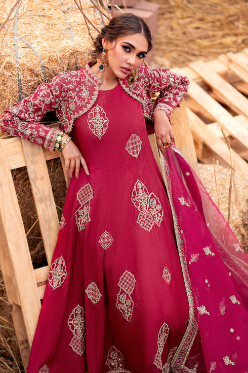 Model wearing full Naqshi Samar 3PC set: carrot orange paneled frock, open embroidered jacket and ornate organza dupatta styled elegantly for festive occasions.