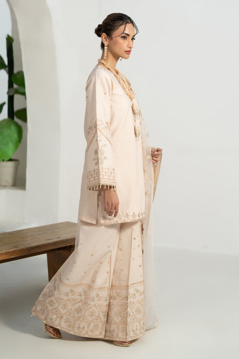 Side profile of NAQSHI Soni outfit showing loose sleeves with embroidered motifs and lace-trim cuff
