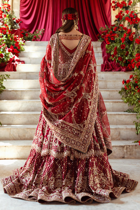 Side profile of NAQSHI Jhankar showcasing dramatic floor-length kalidar flare with scalloped panel layers, mid-slit lehenga peek, fitted sleeve ends and crystalized hangings at frock edge.