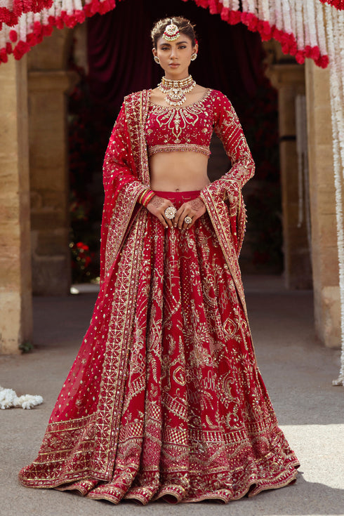 NAQSHI Qurbat fuchsia red bridal raw-silk lehenga front view with round embroidered neckline, scalloped three-quarter sleeves, richly hand-adda embellished choli, and layered lehenga.