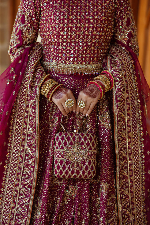 Detailed image of lehenga hem featuring layered embellished borders, heavy hand‑adda work, sequin and crystal accents with fine lace finishing.