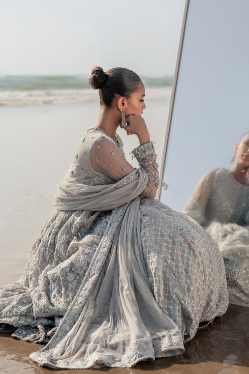 NAQSHI Valeria silver net dupatta draped elegantly, featuring sequin‑line sprays, embroidered luxe pallu border with contrasting hues and delicate floral accents.