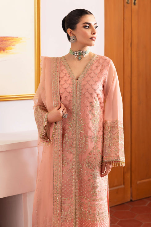 Detailed shot of NAQSHI Muzna sleeve end featuring crystal‑trimmed lace, hand‑made hangings and finely stitched embroidery on flamingo‑pink organza.
