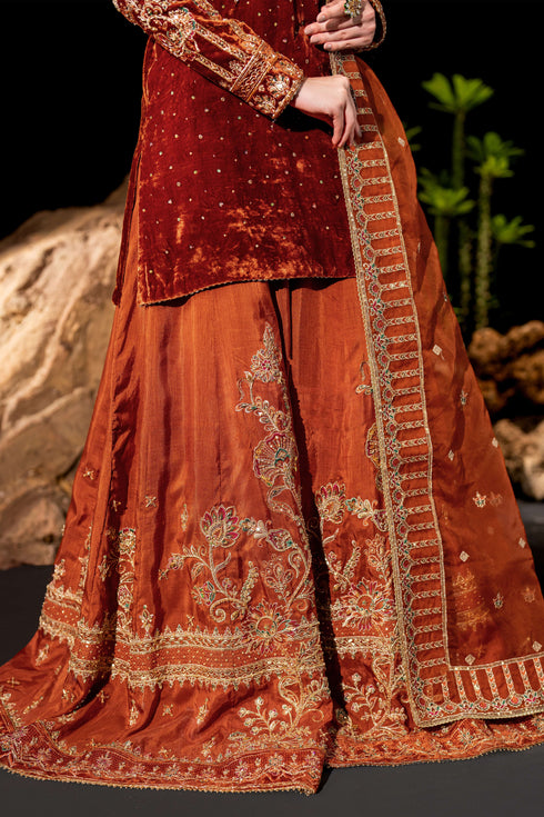 Seated portrait view of NAQSHI Amber outfit highlighting embellished neckline and dupatta drape