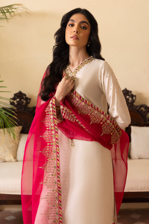 Detailed shot of NAQSHI Abish sleeve cuff showing fine hand-adda embellishments spray, hot‑pink piping finish and subtle thread textures on white raw silk.