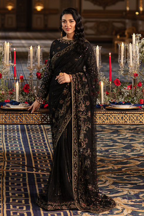 Naqshi Hainoor black net saree with Indian raw‑silk blouse richly adorned in hand‑adda—kora, dabka, threadwork, sequins—and crystal hangings on end, styled with raw‑silk petticoat.