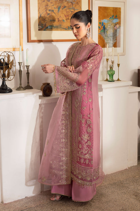 Detailed shot of NAQSHI Nayab showing berry-pink patch embroidery on side panel with textured sequin and floral motif work.