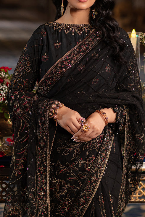 Model wearing full Naqshi Hainoor 3PC set: black embroidered blouse, draped net saree & raw‑silk petticoat styled for evening/formal wear elegance.