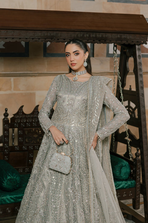 NAQSHI Arminha showing floor-length frock silhouette, full-length sleeves adorned with Islamic motif-inspired jaal embroidery ending in crystal hangings, and flowing embroidered net dupatta.