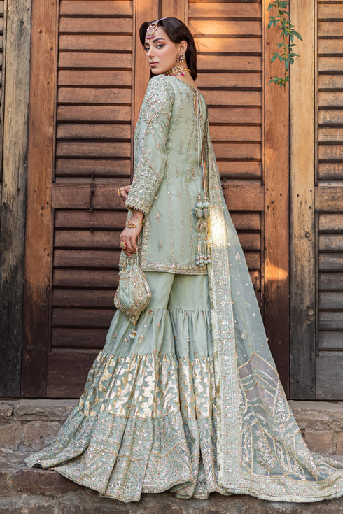 Side view showcasing Mah‑e‑Meer’s short shirt side slits with embellished droplets, layered gypsy gharara volume and elegant raw‑silk cutline.