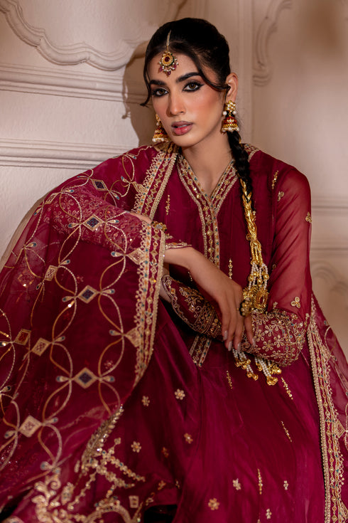 Close‑up of Zaafia hemline featuring heavily adorned sequin‑embroidered border with hand‑adda motifs on magenta organza.