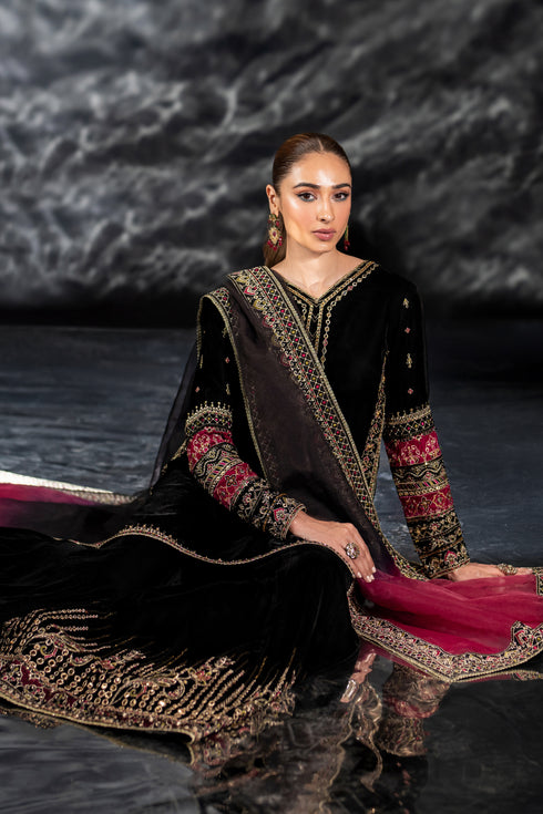 Seated pose of NAQSHI Adhan outfit showing paneled sharara flow, embroidered borders, and elegant drape