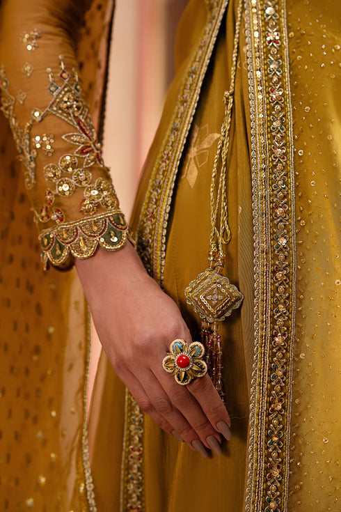 Side profile showcasing the double-layer frock’s side slit and adda-spray embroidery on the upper organza layer.