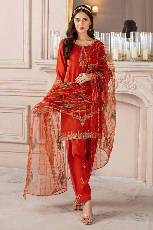Standing pose of Syara orange dress showing straight shalwar and soft dupatta drape, elegant ready made formal outfit.
