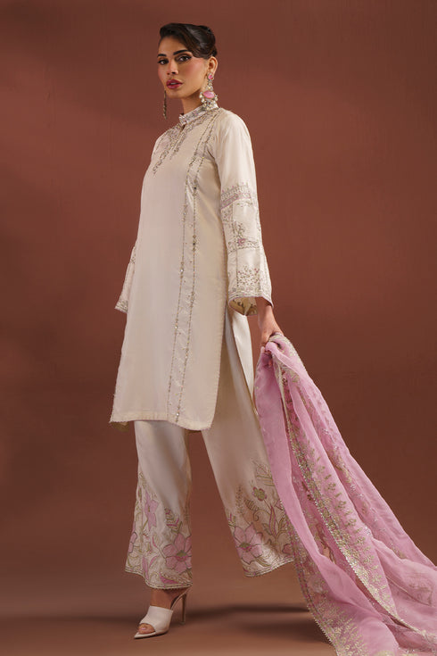 Side view of NAQSHI AMSAH outfit showing short shirt silhouette and embroidered organza dupatta drape