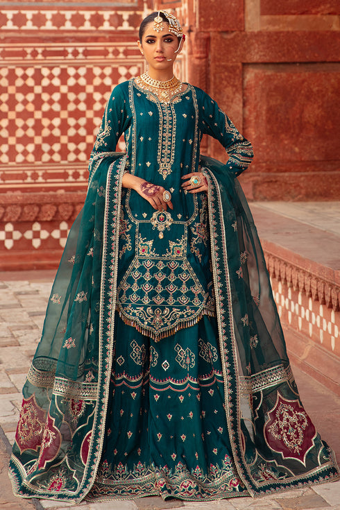 Naqshi Zamurd zinc-grey organza shirt with detailed front embroidery and adda work, paired with Indian raw‑silk sharara and ornate organza dupatta.