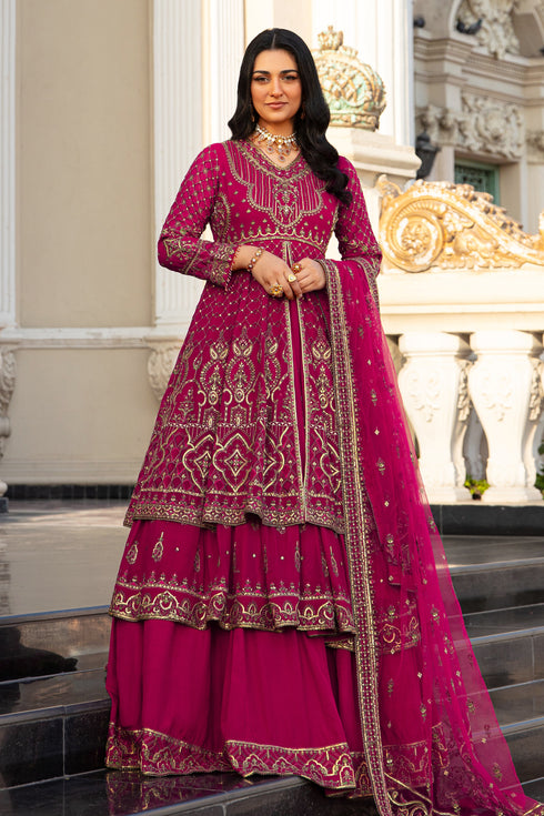 Naqshi Behnaam shocking‑pink georgette layered frock with V-neckline, heavy embroidery, sequin hangings and lace trim, paired with raw‑silk lehenga and embroidered net dupatta.