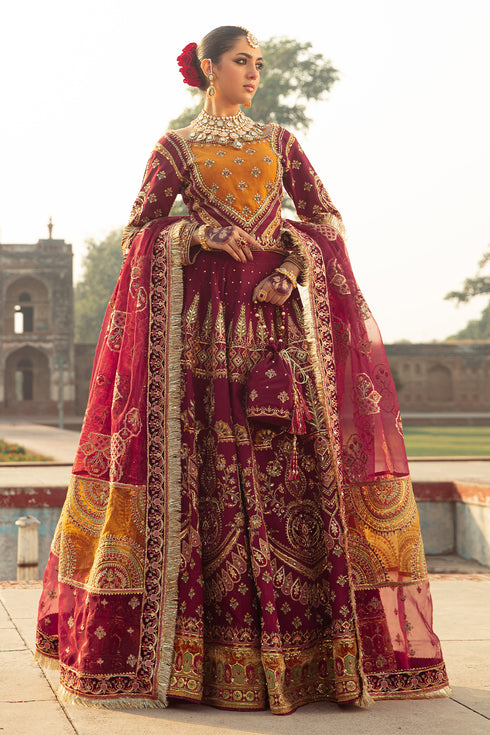 Naqshi Ismat maroon raw‑silk choli with boat neckline, mustard applique and heavy adda embroidery, paired with velvet-hem lehenga and scalloped organza dupatta.