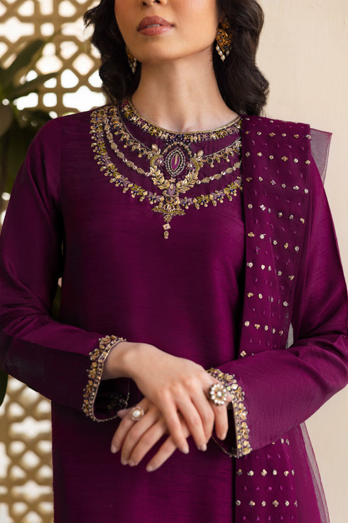 Side view of NAQSHI Irma showing straight-cut raw-silk shirt silhouette adorned with intricate hand-adda embroidery extending along sleeve seams and olive contrast culottes peeking.