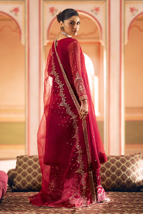 Model side profile showcasing center slit and vertical adda embroidery on frock.