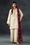 Woman wearing a cream embroidered outfit with a maroon dupatta against a dark background