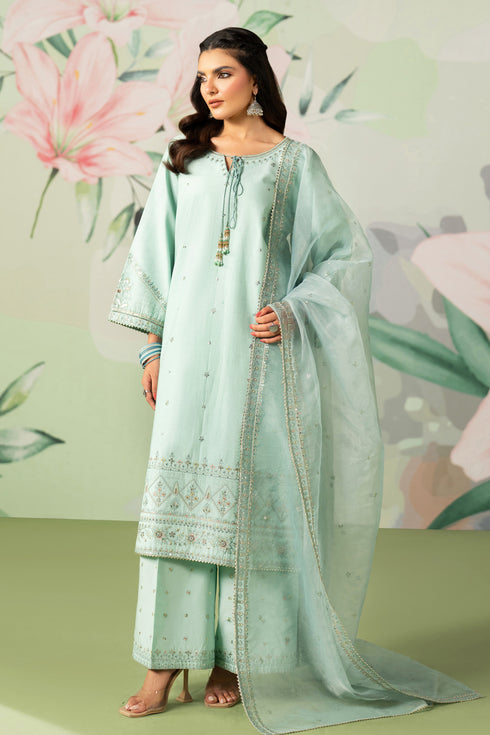 Woman in a light green traditional outfit with floral background