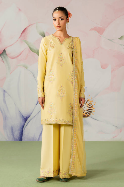 Woman wearing a light yellow embroidered traditional outfit with a floral background